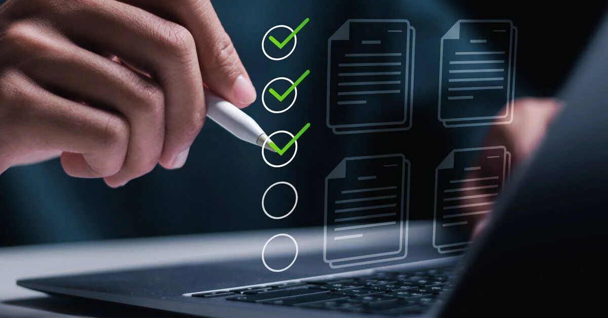 Person checks off items on a vertical checklist projected over a laptop screen, symbolizing a digital task workflow.